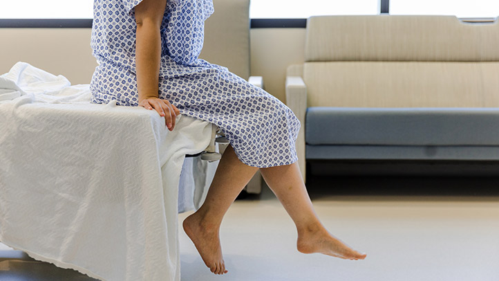 woman sitting on treatment table in fertility clinic