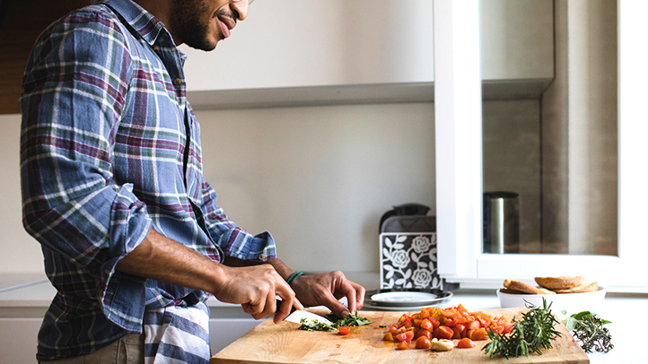 fertility foods for men, man chopping vegetables