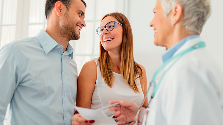 pregnant couple with doctor, in-vitro fertilization and ivf