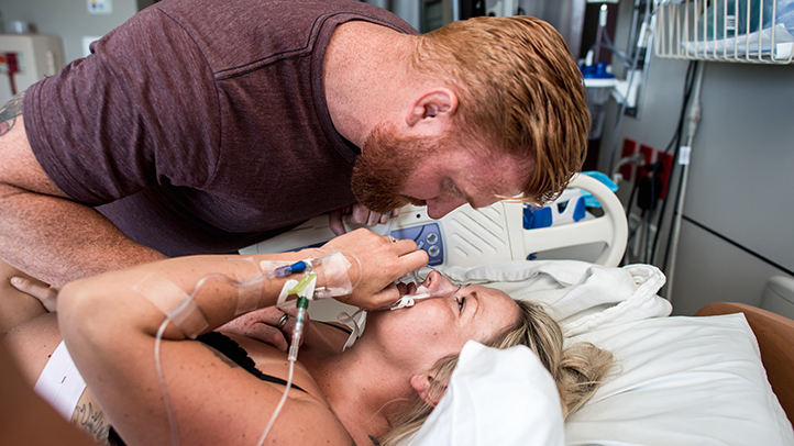 woman in labor holding nitrous oxide mask during labor