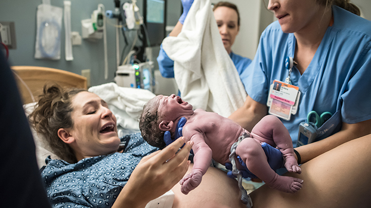 baby is delivered as mom pushes baby out