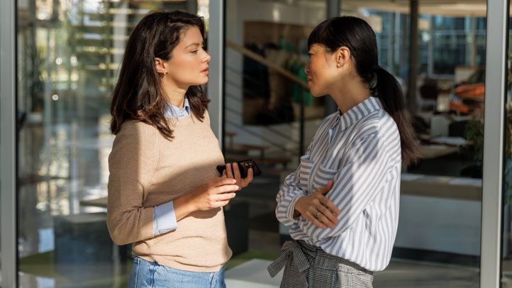 pregnant woman telling her boss she's expecting