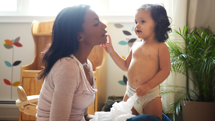 toddler girl in pull-up with mom, signs your toddler is ready to be potty trained